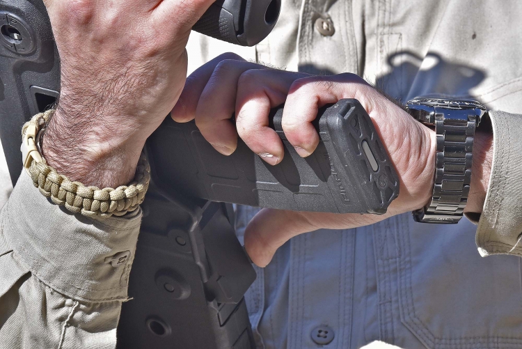 The slide stop catch is located right behind the magazine well, just in the right position to be activated with the shooter's thumb when inserting the magazine, but there are downsides with that too
