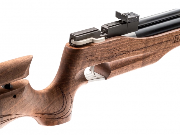 The wooden stock features a traditional competition pistol grip