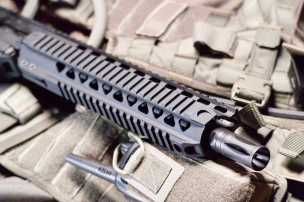 The handguard is provided with quad picatinny rails. A QD cup is on the bottom forward end. The muzzle has a birdcage flash hider.