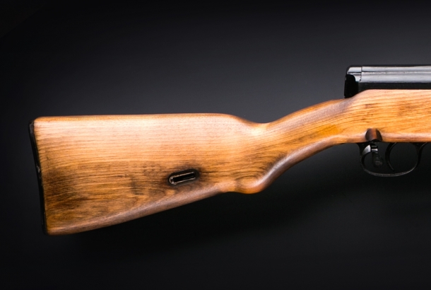 A close-up of the wooden stock of the Molot KO-SVT rifle