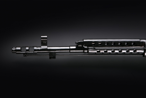 The barrel of the KO-SVT rifle features a prominent flash hider and muzzle brake