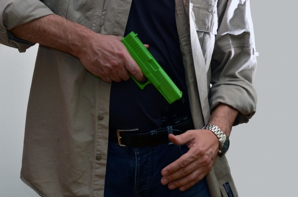 Cross-draw carry slows down extraction and prompts safety errors such as pointing the gun against bystanders or the shooter's body before aligning the sights on the target – or, like in this case, putting the finger on the trigger too soon