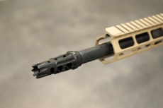 The flash hider of the BCM-15, attached to the muzzle of a multi-radially rifled barrel